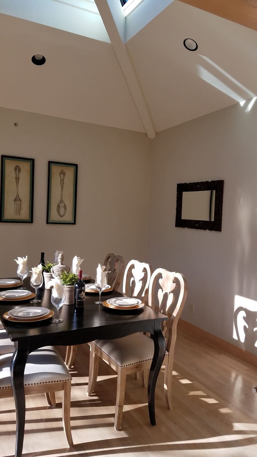 Bright dining room with freshly painted vaulted ceiling and warm neutral walls filled with natural light